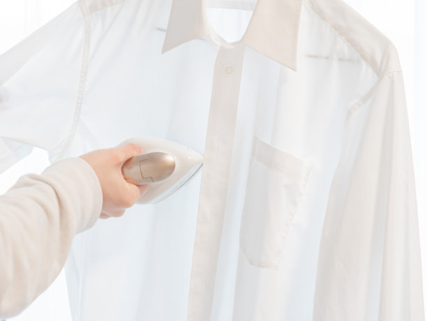 用熨衣机熨衬衫。图片下载