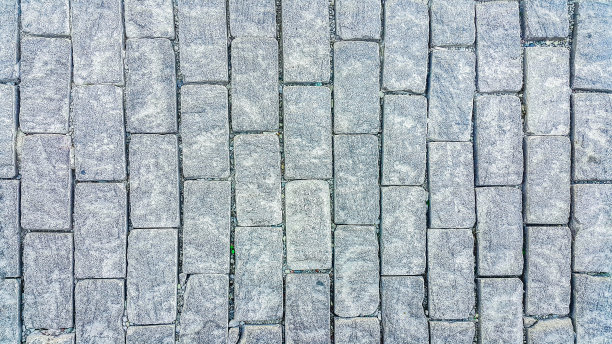 人行道上。矩形的鹅卵石。建筑行业。石头的背景。为文本复制空间。图片下载