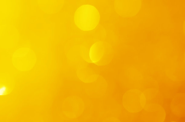 闪烁的灯光闪耀黄色金色华丽的散焦抽象背景闪亮。图片下载