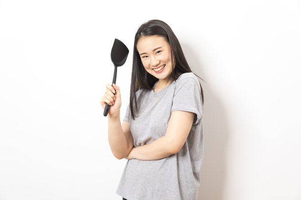 白底黑勺的亚洲家庭主妇。图片下载