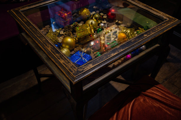 古董木桌，玻璃桌面下有圣诞小装饰品图片下载