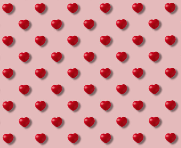红色的心在粉红色的背景图案图片下载