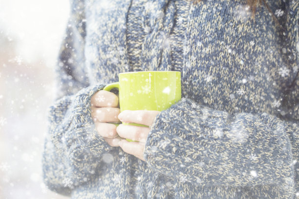 冬日的户外，女人手里拿着一杯热咖啡图片下载