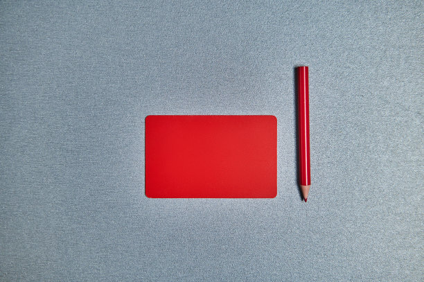 用红色卡片和红色铅笔平躺在灰色的背景上。本空间图片下载