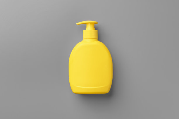 黄色化妆品容器上的灰色背景俯视图图片下载