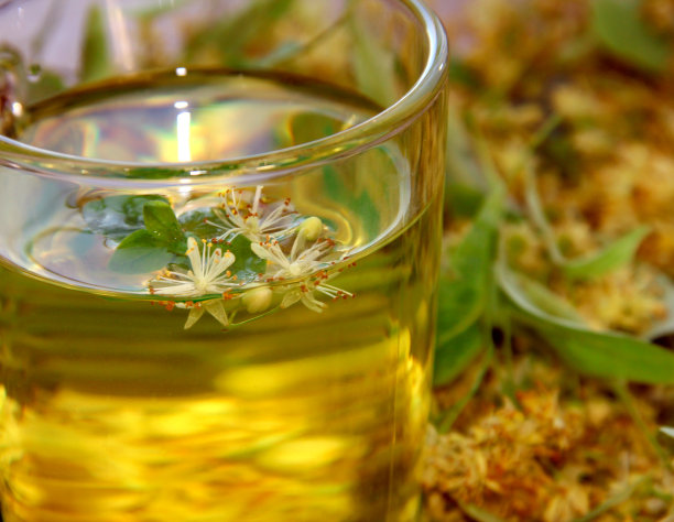 一杯酸橙茶，背景是酸橙花。图片下载