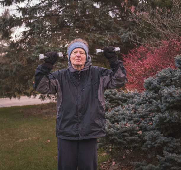 老年人在户外进行举重锻炼图片下载