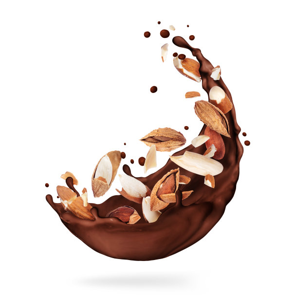 巧克力与碎杏仁飞溅在白色的背景特写图片下载