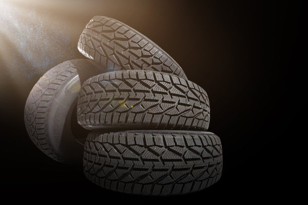 堆叠四个新的黑色轮胎的冬季汽车在黑色的背景图片下载