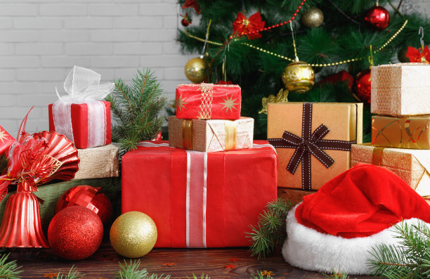 有珠子的礼盒，玩具和圣诞老人的帽子放在复古的木头桌子上图片下载