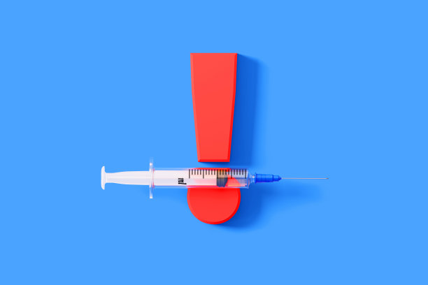 注射器坐在一个巨大的红色感叹号在蓝色的背景图片下载