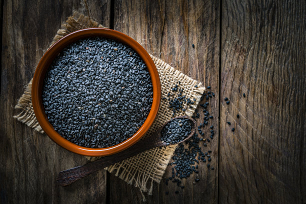 一碗黑芝麻放在质朴的木桌上。本空间图片下载