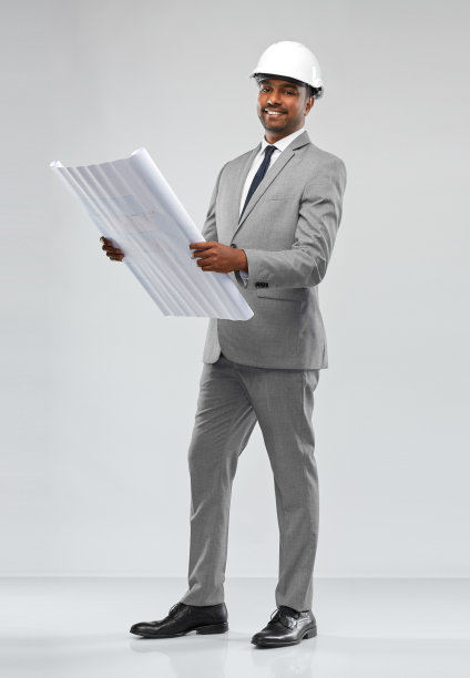 印度男建筑师戴着头盔，戴着蓝图图片下载
