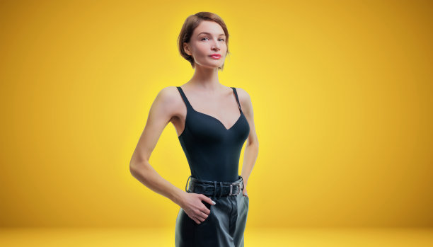 一位美丽高挑苗条的女性的肖像。她在黄色背景的工作室里摆姿势。风格和美丽身材的概念图片下载