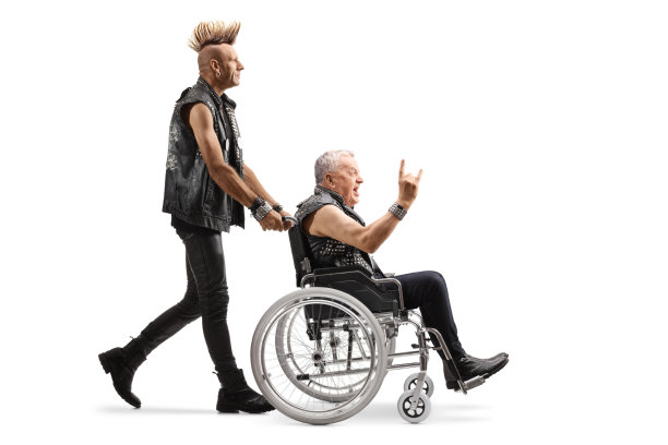 一个穿着皮衣，留着莫西干头的男人推着一个坐轮椅的成熟朋克图片下载
