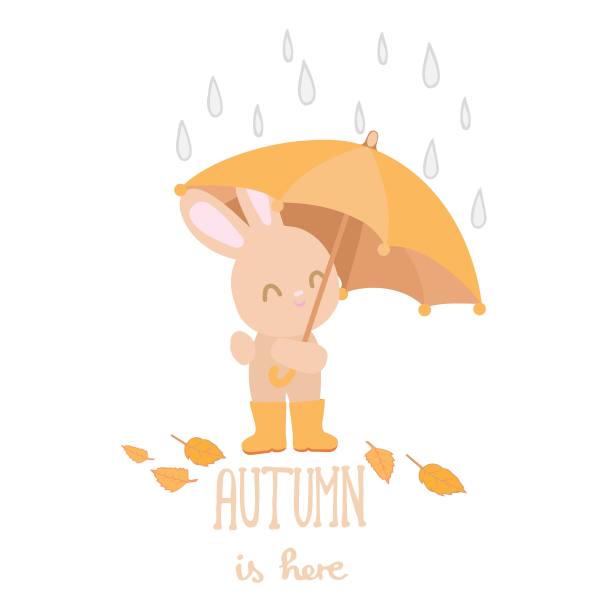 兔子带着伞和文字秋天在这里的白色背景图片下载