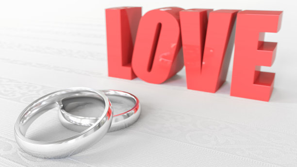 微距上一对孤立的结婚戒指躺在白色桌布前的爱情字3d渲染图片下载