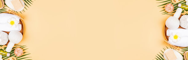 Spa按摩芳香疗法身体护理背景。水疗草药球，化妆品，毛巾和热带树叶在橙色的桌子上。俯视图，平铺，头顶，拷贝空间。美容保健理念图片下载