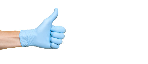 戴着蓝色乳胶手套的医生竖起大拇指图片下载