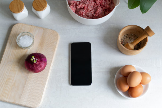 在线烹饪课程。智能手机是家庭厨房中的一种产品。图片下载