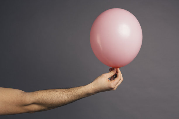 手持粉色气球图片下载