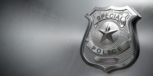 金属背景的警察金属徽章。警察的标志和象征。图片下载