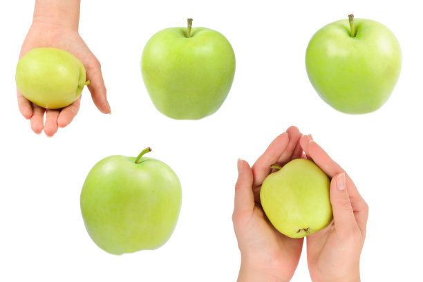 青苹果在女人的手孤立在白色的背景。图片下载