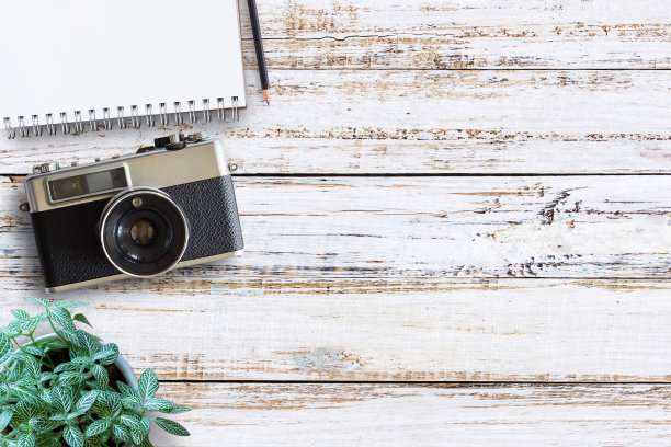 办公室书桌木桌与古董相机和鲜花。顶部视图与复制空间。图片下载