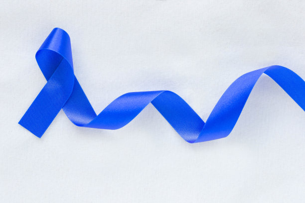 深蓝色的缎带卷曲在白色织物与复制空间。大肠癌意识，老年人结肠癌和世界糖尿病日，儿童虐待预防。医疗保险的概念。图片下载