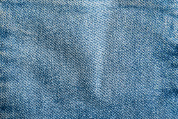 牛仔裤的纹理接近。纺织品的背景。牛仔蓝图片下载