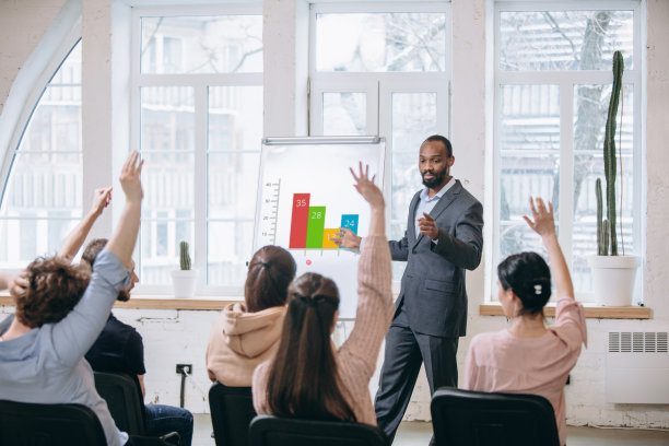 男演讲人在车间大厅演讲。观众或会议厅。未被认出的参与者的后视图。图片下载