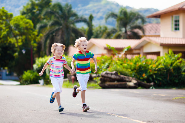 孩子跑步。孩子们在城市的街道上奔跑。图片下载