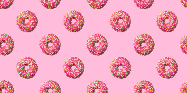 粉红釉面甜甜圈无缝图案在粉红色的背景。概念的食物图片下载