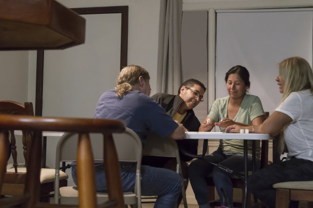多代多种族美籍/拉丁家庭周六晚上在家玩多米诺骨牌图片下载