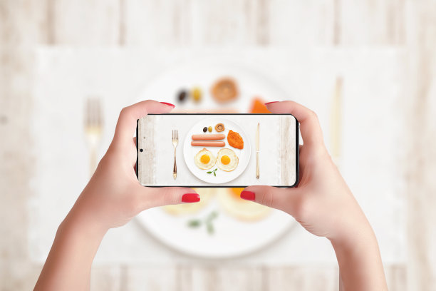 用手机给早餐拍照。拿着智能手机的女人在水平位置图片下载