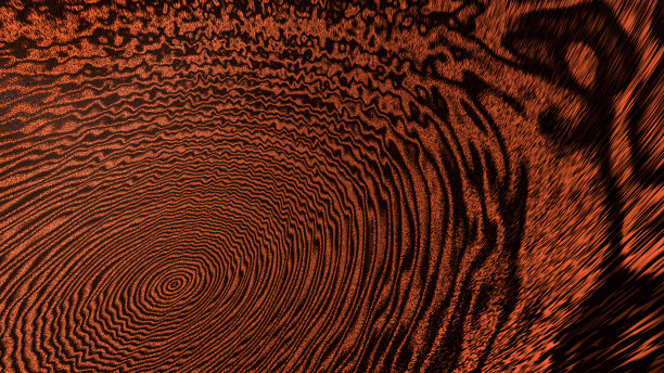 粗糙的棕色抽象背景创造了从一个半球的中心区域向外移动的黑色圆圈图片下载