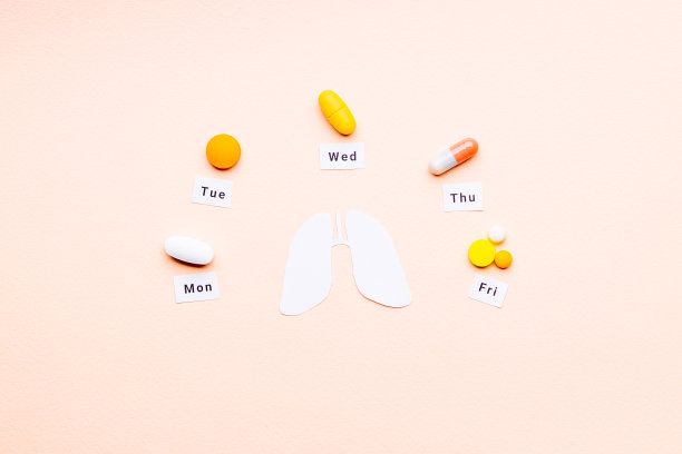 肺癌药物的概念。多种药物和药丸靠近肺部标志在粉红色的背景。外太空图片下载