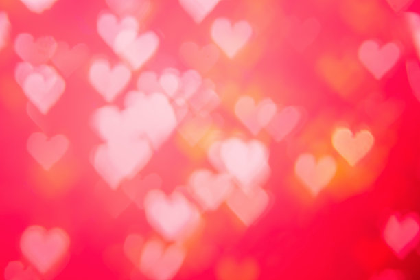 红色热辣，激情四射，魅力四射，背景明艳散景。心形的虚景红色抽象背景横幅。爱情主题说明。情人节的概念。副本的空间。装饰亮片设计。图片下载