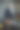优雅的情侣相爱。一男一女在暗室里。一个穿黑裙子的女孩坐在椅子上，一个穿西装的秃顶男人靠墙站在阁楼上。垂直的照片。情人节图片下载