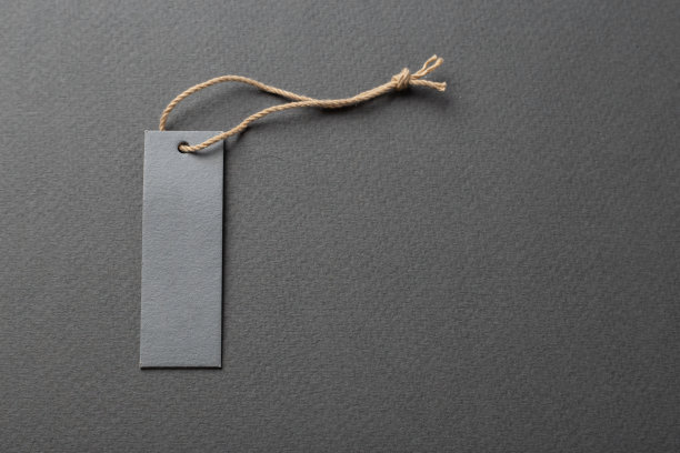 服装标签，标签空白的样板纸上的背景。图片下载