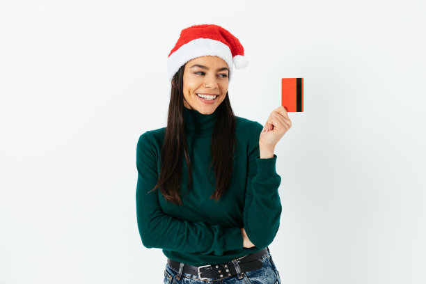 戴着圣诞老人帽，手里拿着银行卡的女人图片下载