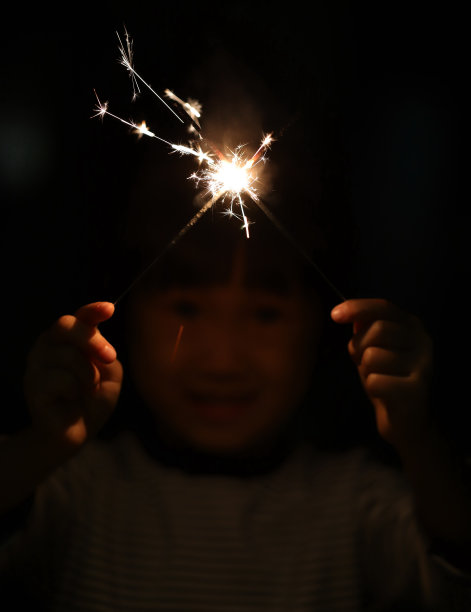 两个微笑的亚洲女孩在中国新年玩烟花图片下载