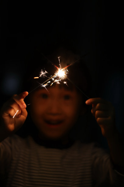 两个微笑的亚洲女孩在中国新年玩烟花图片下载
