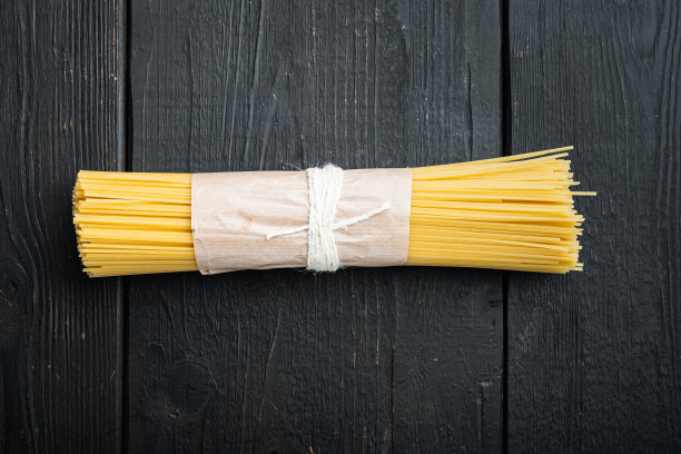 干意大利面，黑色木桌背景，俯视图平铺图片下载