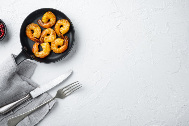 烤虾烧烤风格混合辣，在煎铁锅上，在白色背景上，俯视图平铺，与copyspace和文字空间图片下载