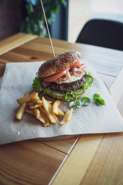 在餐馆里提供牛肉汉堡和薯条。烤牛肉汉堡在Sezame面包。图片下载