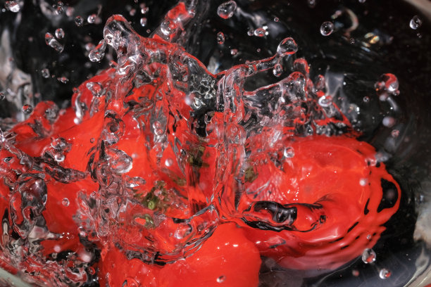 红色的小西红柿掉进玻璃碗里图片下载