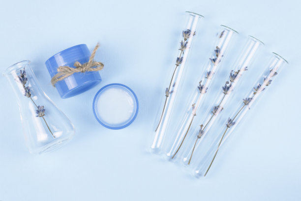 蓝色背景上的薰衣草天然化妆品试管和罐子。薰衣草冰淇淋。图片下载