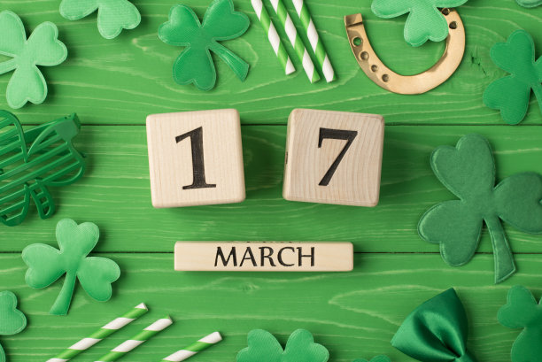 圣帕特里克节快乐。头顶上方近距离平放视图照片图片木制立方体日历与日期和派对配件孤立亮颜色绿色背景图片下载