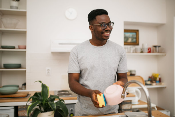 快乐的非裔美国人在家里洗碗图片下载